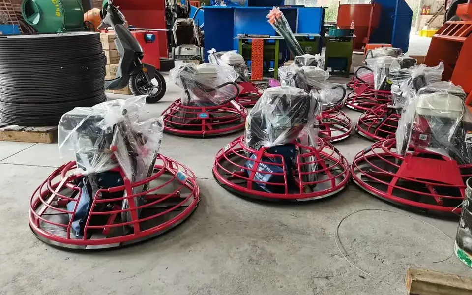 Multiple concrete trowel machines photographed inside the factory