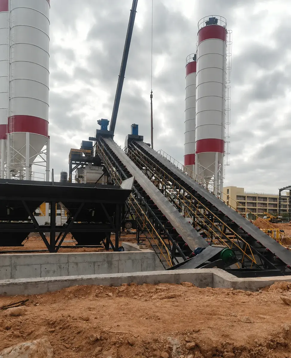 Actual photos of twin-line concrete batching plant main building and two-way inclined conveying system during installation stage